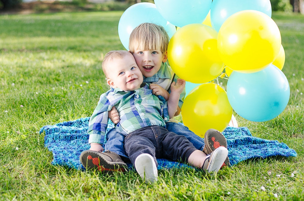 Brothers with balloons at the park. Marina Family Photography