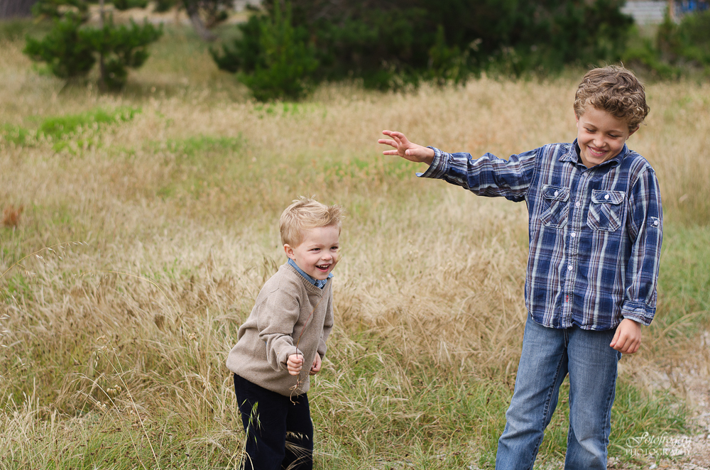 Two brothers playing in tall grass Pacific Grove portraits