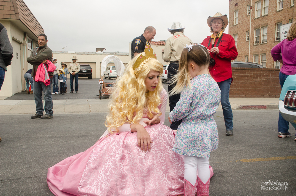 Little girl talks to princess in a pink gown