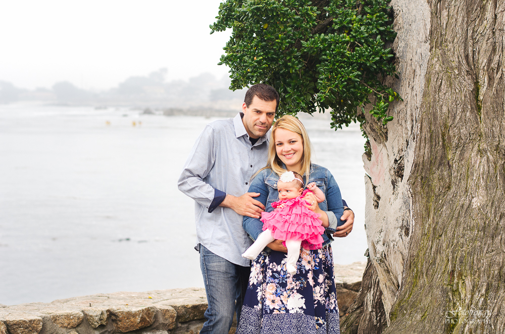 Cute family photo baby girl in pink by a tree and oceanview, Lovers Point Pacific Grove Ca