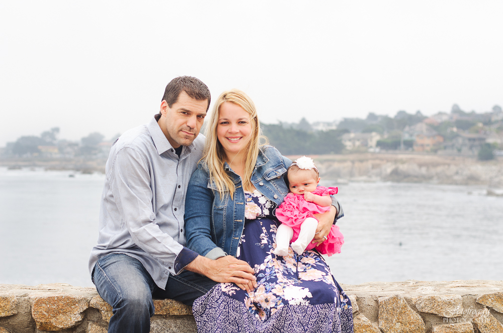 Family of three in front of ocean Pacific Grove Ca