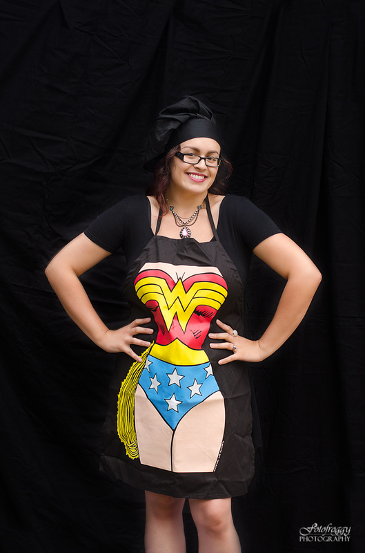 Giving Into Cyn - YouTube - Headshots - Wonder Woman apron on black 