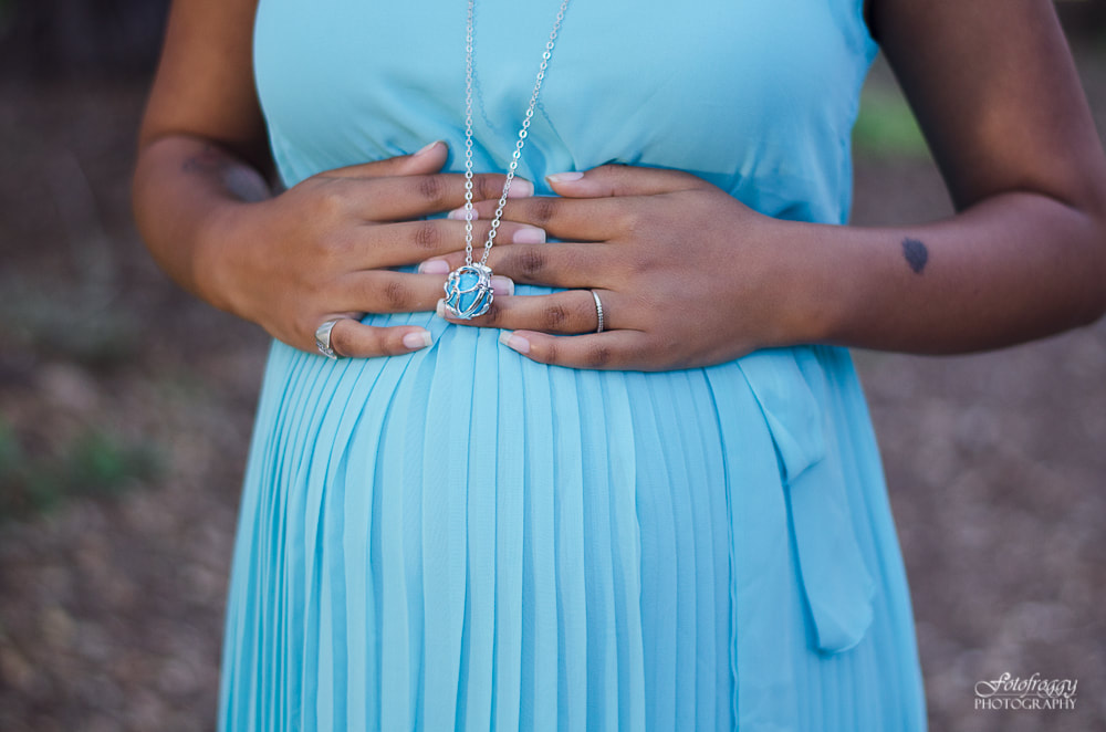 Maternity portrait. Baby bump in light blue with matching Harmony necklace. www.fotofroggy.com