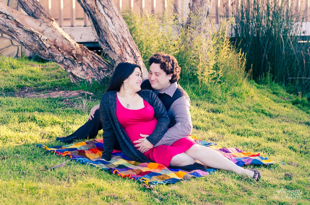 Couple's maternity portrait on colorful blanket. Fotofroggy Photography, Monterey Bay family portraits.