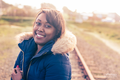 Beautiful woman with cozy jacket on train tracks - fotofroggy.com